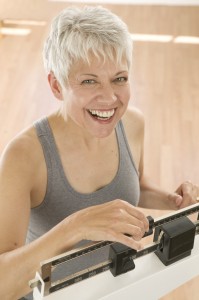 Woman Weighing Herself on a Scale